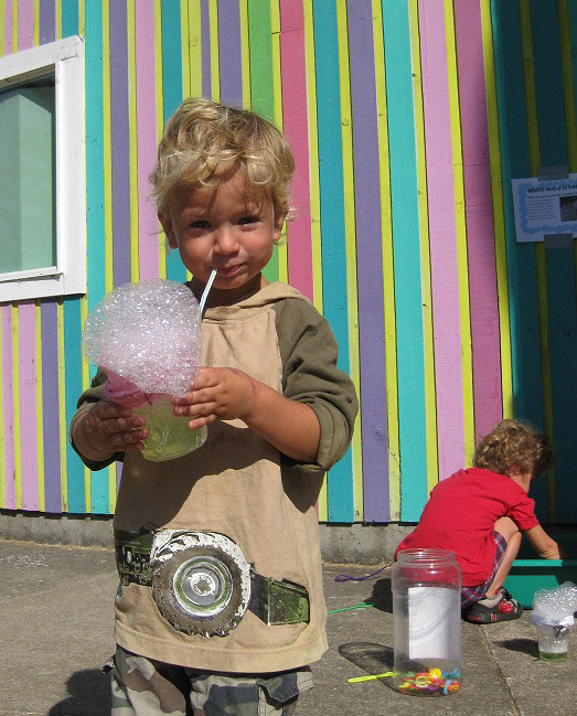 little boy blowing bubbles