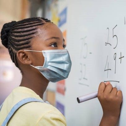 Girl in Mask Does Math on Whiteboard